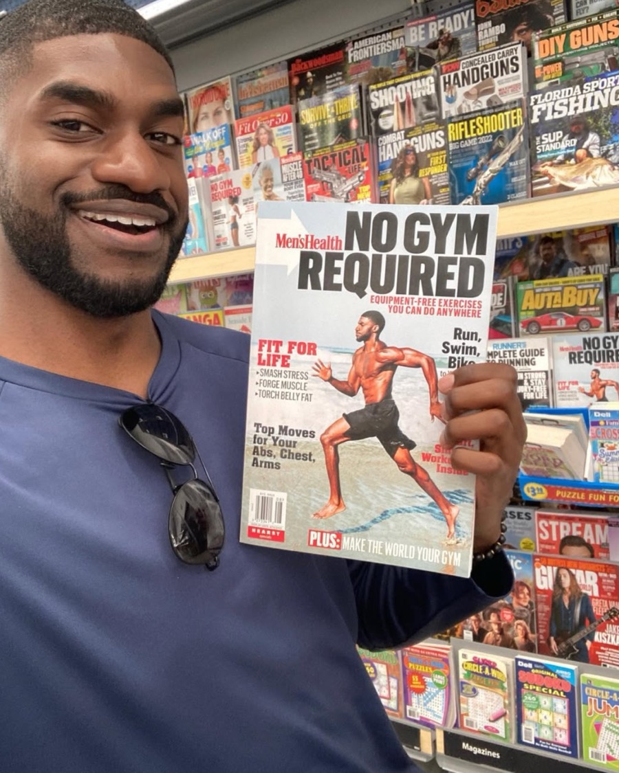 Calvin holding the Men's Health issue he's on the cover of