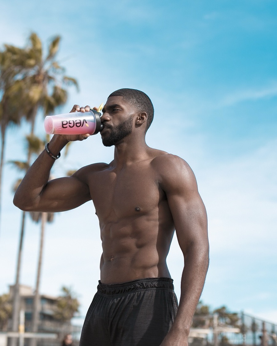 Calvin with a shaker under the palms